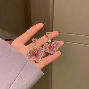 Elegant purple rhinestone heart dangle earrings with pearl accent on silver needle