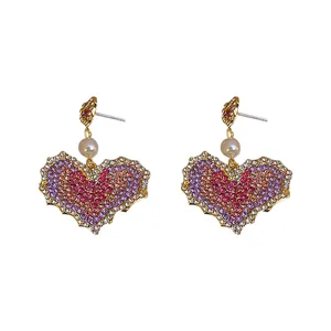 Exaggerated purple rhinestone heart earrings with pearl accents for women