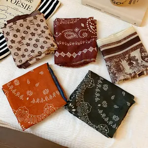 Detail view of five assorted vintage scarves with paisley and artistic landscape prints