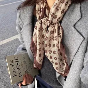Close-up of vintage printed scarf necklace with MY pattern for chic autumn and winter outfits