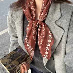 Close-up of retro reddish-brown paisley patterned neck scarf for autumn and winter outfits