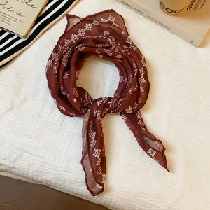 Close-up of vintage wine red paisley bandana with intricate white geometric patterns