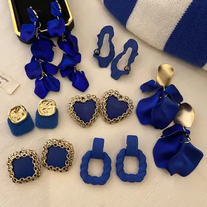 Vintage Klein blue and gold earring set featuring heart shapes and petal tassel designs