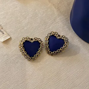 Vintage Klein blue heart earrings with golden hollow chain border for a retro chic look