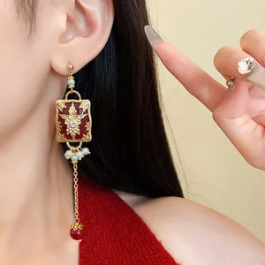 Elegant vintage long drop earrings with red enamel and faux pearls shown worn on ear
