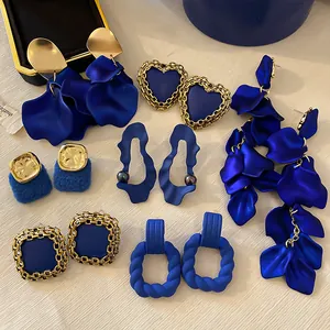 Collection of Klein Blue statement earrings in various heart and floral petal designs