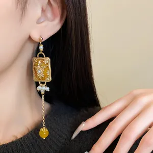 Detailed close-up showing vintage flower drop earrings with pearls and beads on a model