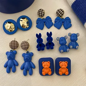 Assorted Klein blue earrings set with teddy bears, rabbits, bows, and houndstooth patterns