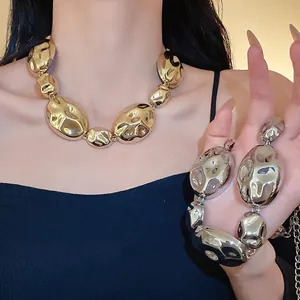 Chunky gold and silver wrinkled oval metal statement necklace with exaggerated design