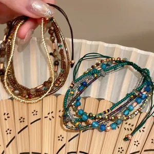 Macro view of vintage ethnic multi-layered beaded bracelets with adjustable drawstring closure
