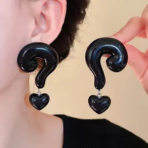 Oversized black question mark earrings with heart charms for a unique fashion statement.