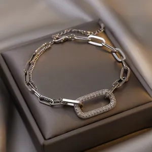 Detailed macro shot of a geometric silver chain bracelet with shimmering rhinestones.