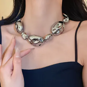 Detailed close-up of a chunky silver metallic crumpled oval link necklace for women