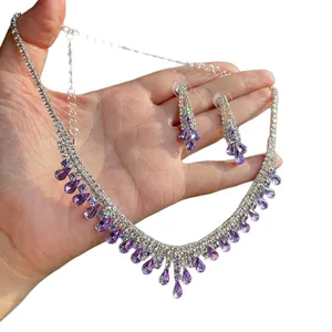 Exquisite silver-tone necklace and earring set with purple teardrop crystals