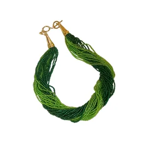 Elegant bohemian multi-layer green seed bead necklace featuring vintage gold-toned clasp