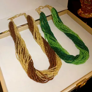 Detail view of Bohemian multi-layered seed bead necklaces in earthy brown and green shades