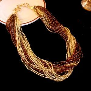Detailed view of bohemian multi-layered seed bead necklace with gold and bronze tones