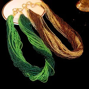 Detailed view of multi-strand bohemian seed bead necklaces in green and brown hues.