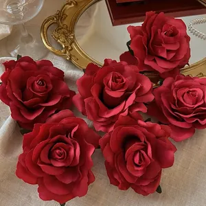 Detailed macro shot of realistic deep red silk rose petals showing fine textures and fabric