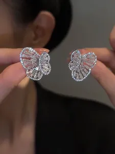 Close-up of sparkling zircon butterfly stud earrings showing intricate stone settings