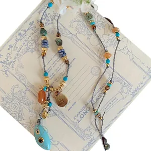 Vintage bohemian multi-colored beaded necklace with a turquoise teardrop pendant charm