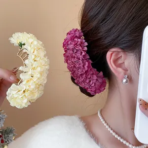 Detail view of elegant New Chinese style fabric flower hair pin for bun hairstyles