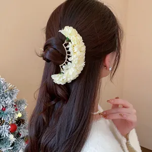 Close-up of elegant New Chinese style fabric flower hair pin with cream white floral design