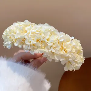 Close-up detail of elegant cream fabric flower petals on a handmade hair pin accessory
