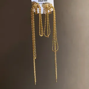 Detail view of 18k gold plated knotted tassel clip-on earrings with elegant finish