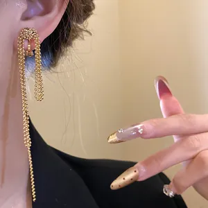 Detailed view of luxury 18k gold plated knotted long bead tassel clip-on earrings for women