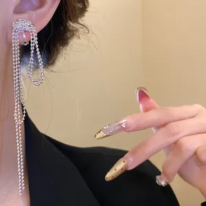 Detailed close-up of a silver multi-strand ball chain knot tassel ear clip on model