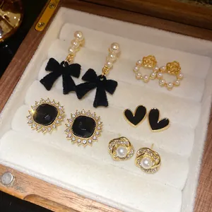 Detail view of vintage French style 10-piece earring set with pearls and bows