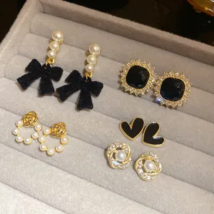 Close-up view of French vintage style earring collection with pearls and bows