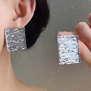 Textured silver geometric square stud earrings for a modern and minimalist look