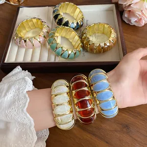 Detailed view of colorful marble acrylic stretch bracelets with gold spacers
