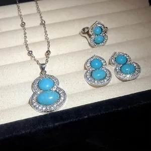 Elegant silver gourd jewelry set with turquoise and rhinestones in display box