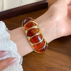 Close-up of French vintage amber acrylic geometric elastic bracelet on wrist