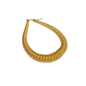 Bold oversized gold-toned collar necklace with a textured spring faceted design