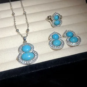 Detailed close-up of gourd-shaped jewelry set featuring turquoise stones and crystal pavé