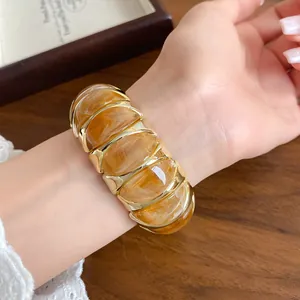 Close-up shot of a French style marble acrylic geometric elastic bracelet worn on a wrist