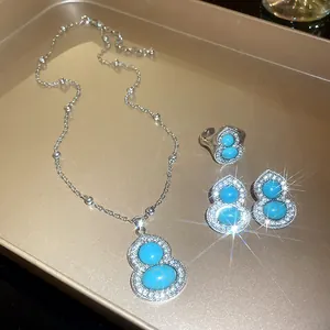 Elegant silver gourd jewelry set featuring turquoise-style stones and sparkling diamond accents