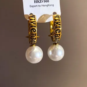 Vintage gold hoop earrings with white faux pearl dangles and engraved lettering details