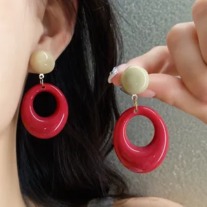 Retro red resin oval pendant earrings with beige stud detail