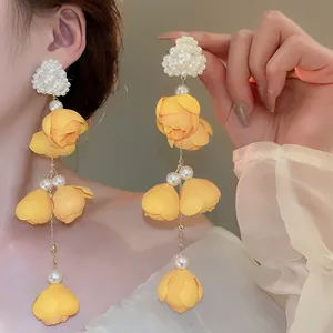 Elegant yellow flower tassel earrings featuring pearls in a sweet dopamine style.