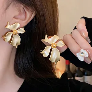 Elegantes pendientes de botón con forma de flor en oro mate de estilo vintage