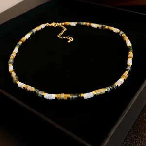 Detailed close-up view of a chic retro necklace with colorful beads in a luxury black box.