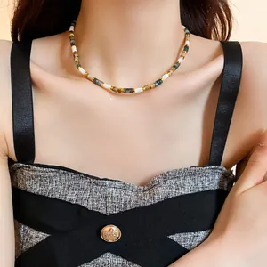 Close-up of a stylish vintage beaded collarbone necklace with multi-colored stone beads.