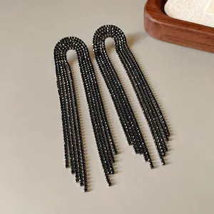 Close-up detail of elegant black rhinestone long tassel earrings for glamorous party wear