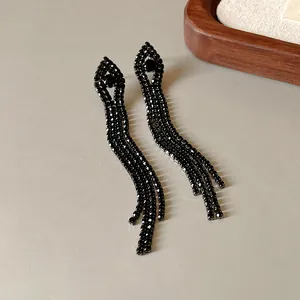 Detailed close-up view of elegant black rhinestone long tassel earrings with sparkling crystals