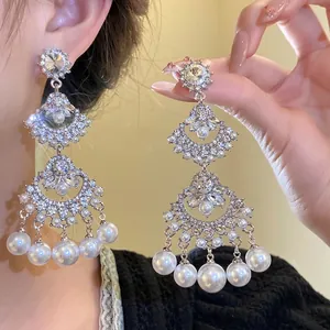 Vintage fan-shaped tassel earrings with rhinestones and pearls on silver needles.